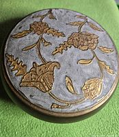 Top view showing embossed floral brass design