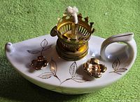 Lamp full view left side showing shape, handle, burner, gold accents