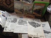 Overview of three Railroad magazines and assorted loose automobile advertisement pages