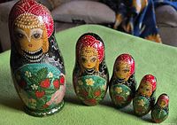 Front view of all five nesting dolls lined up by size