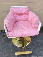 Full view of Baasha pink-cushioned salon chair on gold pedestal base