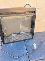 Front view showing glass window, log bed, power cord