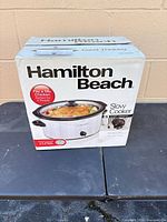 Front of original box showing Hamilton Beach 5-quart oval slow cooker imagery and specifications