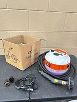 Overall lot with steam cleaner canister, hose, power cord, two brush heads, cardboard box