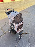 Front/side view showing stroller fabric, mesh panels, wheel configuration