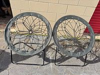 Both saucer chairs side by side on pavement showing overall design and condition