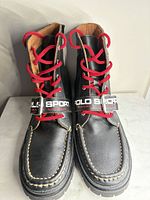 Front view pair boots showing laces, strap, stitching