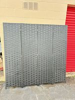 Front view of 4-panel grey woven room divider