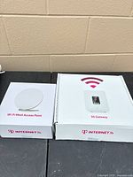 Boxes of T-Mobile 5G Gateway and Wi-Fi Mesh Access Point