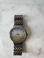 Front view of wristwatch showing dial, hands and bracelet