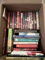 Open box showing vertical row of Love Inspired paperbacks and horizontal stack of hardcovers/paperbacks