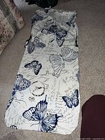 Cover laid flat showing butterfly pattern, elastic edges, drawstrings