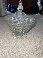 Front view of clear pressed glass candy dish with lid and pedestal base