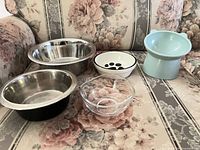 All five bowls displayed: two stainless steel, one ceramic, one glass, one plastic