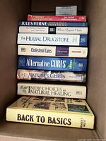 Stack of eight books showing spines and titles