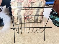 Front view of matte black wire magazine rack