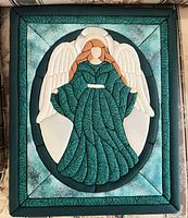 Front view showing complete quilted angel design and border