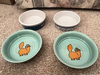 All four ceramic bowls displayed top view on carpet