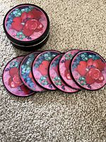 Coasters stacked in tin beside row of coasters