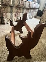 Angled view showing carved hardwood side panels and twin rails