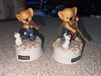 Two ceramic musical bear figurines side by side showing overall design and size