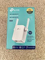 Front of TP-Link RE305 retail box showing product image and specifications