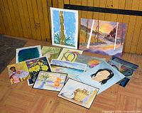 Group shot of all thirteen paintings laid out for overview