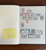 Album page with numerous animal stamps and sticky note stating 250 stamps