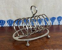 Side view showing oval base, eight dividers, claw feet