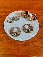 Overview of three earring pairs on felt pad