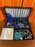 Overview of open jewelry box showing assorted contents