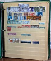 Album open showing several pages of ship stamps