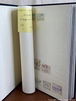 Album spine opened with rolled page and some horse stamps visible