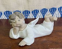 Front view of Lladro reclining angel figurine