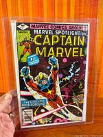 Front cover of Marvel Spotlight on Captain Marvel #1 shown in protective bag and board