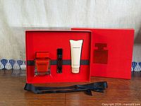 Gift box with three Narciso Rodriguez Rouge items and outer sleeve