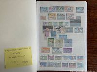 album opened showing first stamp page and note indicating thematic sports collection of 137 stamps