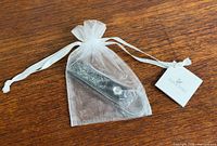 Key ring in organza pouch with Swarovski tag
