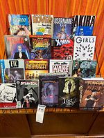 Front view showing fifteen graphic novels on rack
