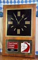 Full view of wood case clock showing face and advertising panel