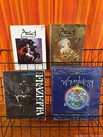Four fantasy books displayed on rack