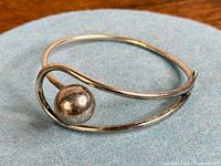 Full view of sterling silver modernist bangle with ball accent