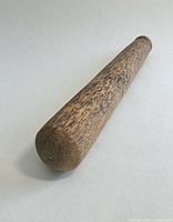 Pestle angled view showing rounded base and grain