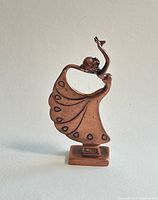 Front view of copper dancing lady figurine