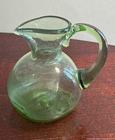 Front view of green glass pitcher