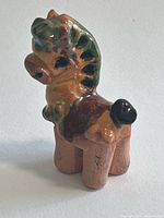 Rear oblique view of glazed ceramic miniature horse