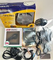 Group shot of all items: Optifix Pro box, aCAN adapter, card reader, mouse, VTIN device, assorted cables