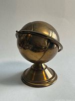 Full view of brass globe on stand