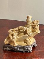 Front view of soapstone statue on wood base