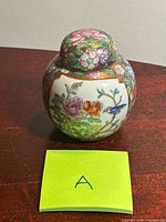 Front view of ginger jar with lid showing primary floral and bird decoration